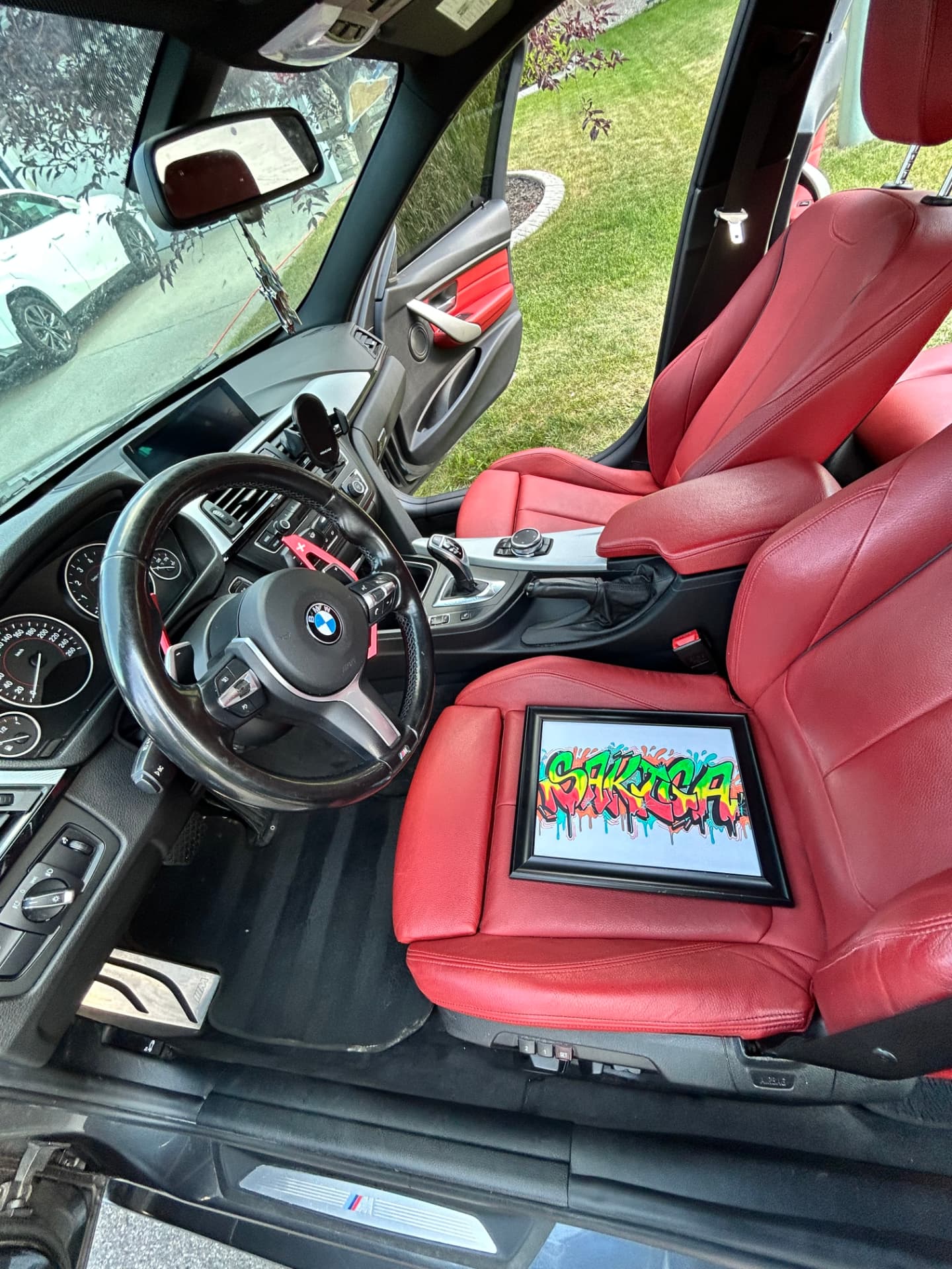 BMW front cabin and driver area with solid-red leather seats