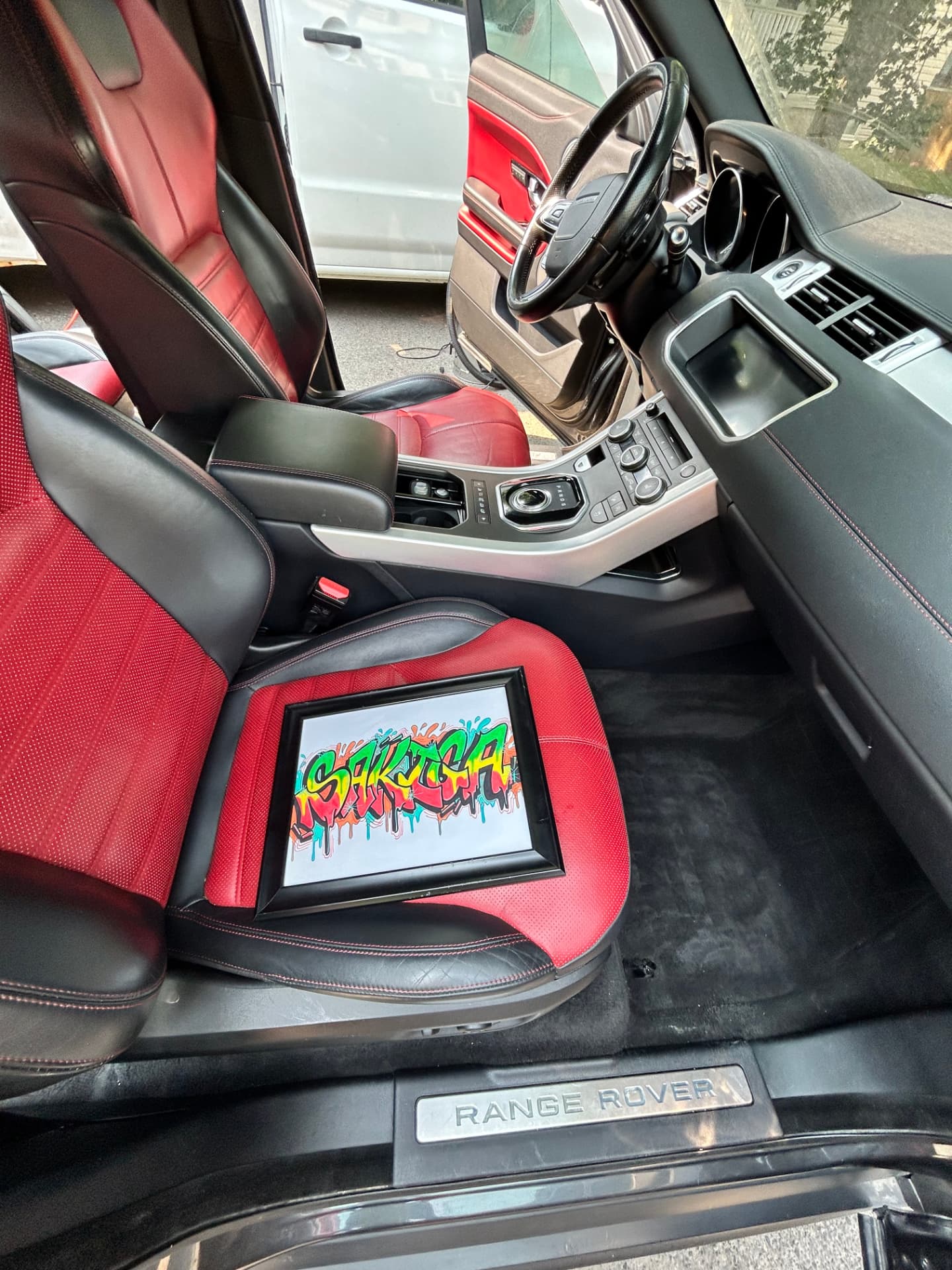 Completed Range Rover front cabin with red and black leather seats after detailing